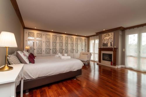 a bedroom with a large bed and a fireplace at Benalmádena Coast Villa in Arroyo de la Miel