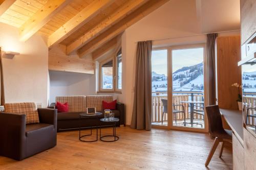 a living room with a couch and a table at Apart-Hotel Dreisonnenhof in Fiss