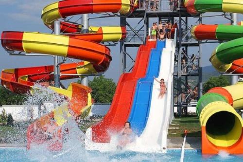a water slide in a water park with people on it at Apartmani Cera in Soko Banja