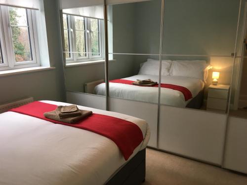 a bedroom with two beds and a mirror at New and Comfortable with Parking in Andover