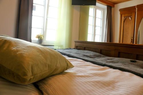 a bed with a pillow sitting on top of it at Ferienweingut Niessner in Ernst