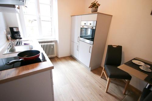 a small kitchen with a sink and a stove at Ferienweingut Niessner in Ernst