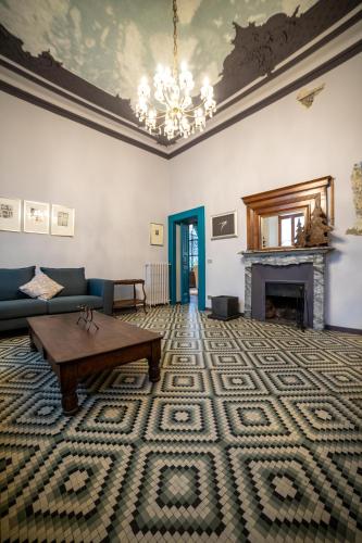a living room with a couch and a fireplace at Hotel Casa Camilla in Verbania