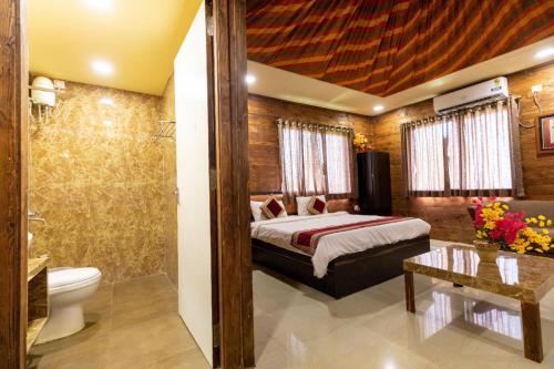 a hotel room with a bed and a bathroom at Bodh Valley Resort in Igatpuri