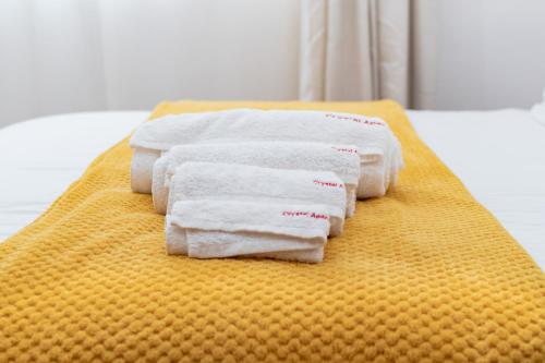 a group of towels sitting on top of a bed at Crystal Apartments in Lilongwe