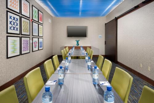 a long table in a room with bottles of water at Holiday Inn Express & Suites by IHG Altoona by IHG in Altoona