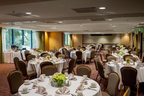 a banquet room with white tables and chairs at Holiday Inn Austin -Town Lake by IHG in Austin