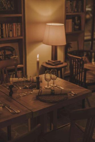a table with a candle and wine glasses on it at HOTEL AMOUR NICE in Nice