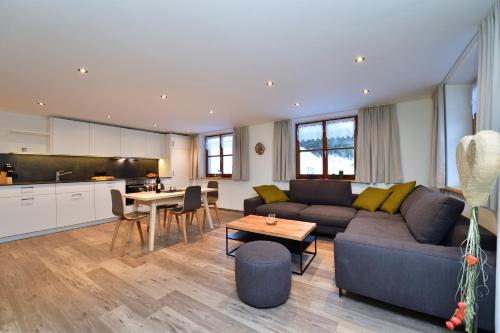 a living room with a couch and a table at Ferienhof Sonne in Hittisau