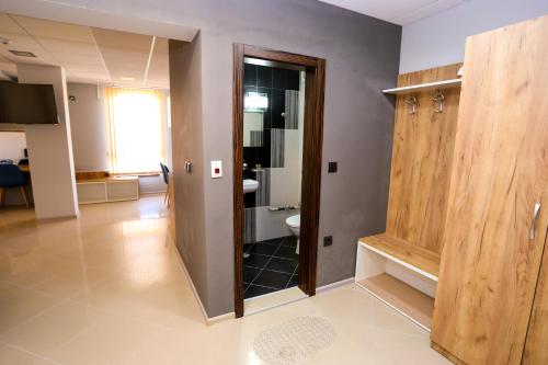 a room with a bathroom with a toilet and a door at Студия и Стаи за гости -жк Пентагон in Kŭrdzhali
