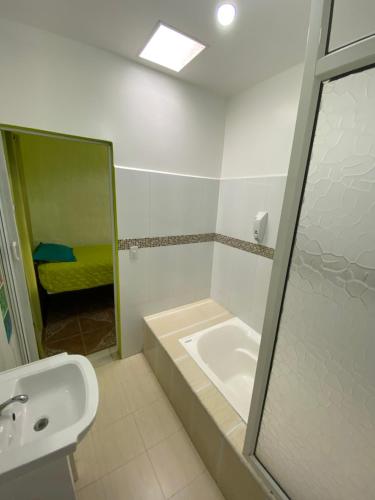 a bathroom with a sink and a shower with a mirror at Zurisadai in Puerto Ayora