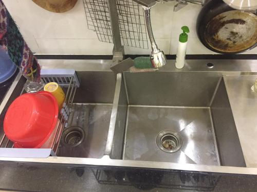 a kitchen sink with a red cup next to it at Moony hostel in Can Tho