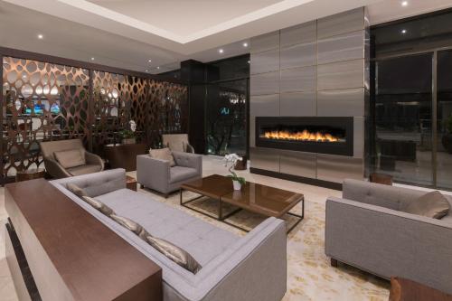 a living room filled with furniture and a fire place at Pan Pacific Toronto in Toronto