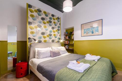 a bedroom with a bed with towels on it at Rome As You Feel - Orti Trastevere Apartment in Rome