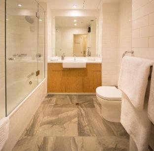 a bathroom with a toilet and a sink and a shower at Villa Del Lago in Queenstown