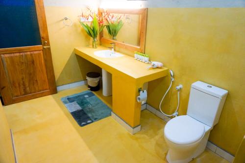 a bathroom with a sink and a toilet and a mirror at Villa Gaetano Unawatuna in Unawatuna
