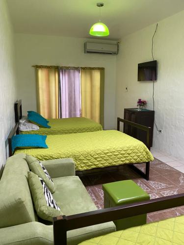 a living room with two beds and a couch at Zurisadai in Puerto Ayora