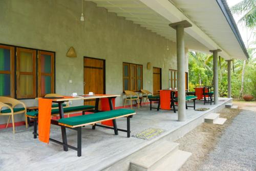 a patio with colorful tables and chairs on a building at Villa Gaetano Unawatuna in Unawatuna