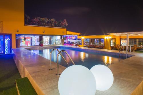 a swimming pool in a building at night at Hôtel Tanjah Flandria in Tangier