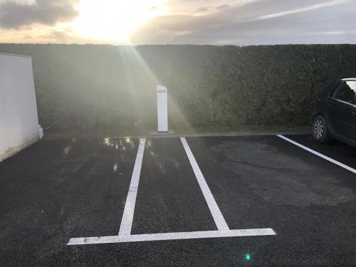 a car parked in a parking lot with a white door at Dream Hotel in Velika Gorica