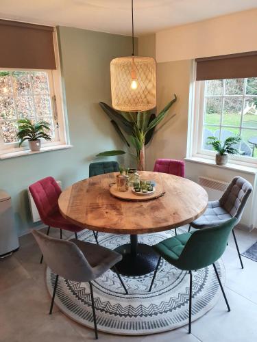a dining room with a wooden table and chairs at Lekker Plekje Achterhoek in Lievelde
