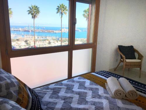 a bedroom with a bed with a view of the ocean at La Cornisa Villa by WaveProperties in Las Palmas de Gran Canaria