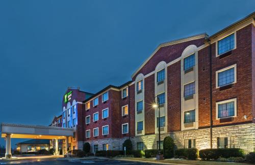 a large brick building with a bridge next to it at Holiday Inn Express & Suites Tulsa S Broken Arrow Hwy 51 by IHG in Broken Arrow