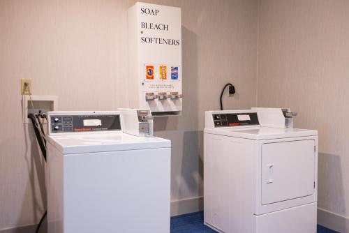 two washing machines sitting next to each other in a room at Holiday Inn Express Branford-New Haven by IHG in Branford