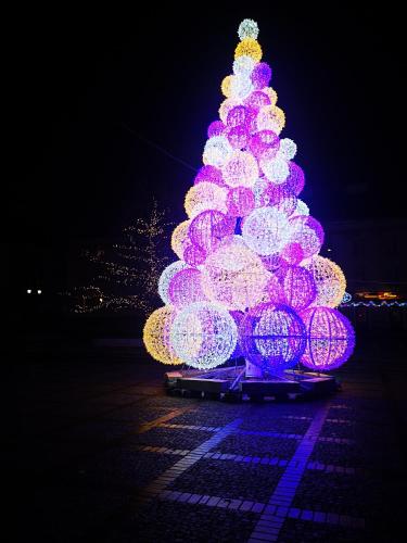 a christmas tree is lit up with lights at Apartament Bednarska Old Town in Warsaw