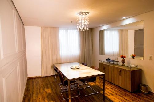 a dining room with a table and a mirror at Blue Tree Premium Manaus in Manaus