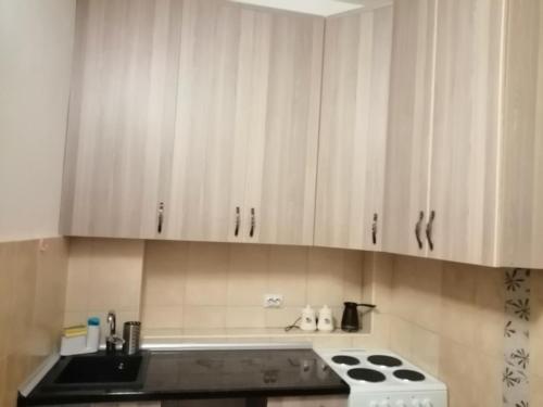 a kitchen with white cabinets and a stove top oven at Apartment Marsala Tita in Bar