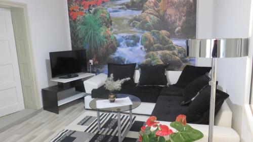 a living room with a couch and a table at Guest House Pavlovic in Soko Banja