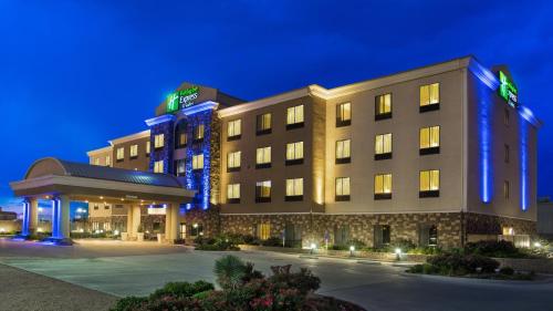 a rendering of a hotel at night at Holiday Inn Express & Suites Midland South I-20 by IHG in Midland