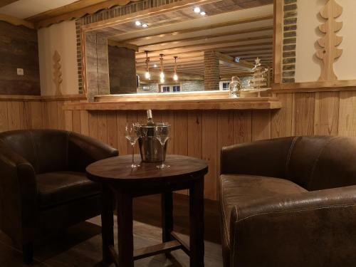 a bar with two chairs and a table in a room at La Sapinière St Lary Soulan in Saint-Lary-Soulan