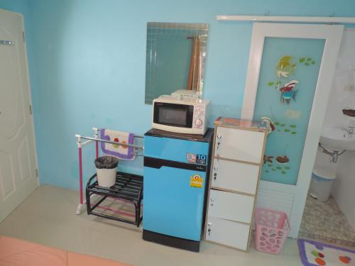 a small kitchen with a microwave on top of a refrigerator at Blue Paradise Residence in Rawai Beach