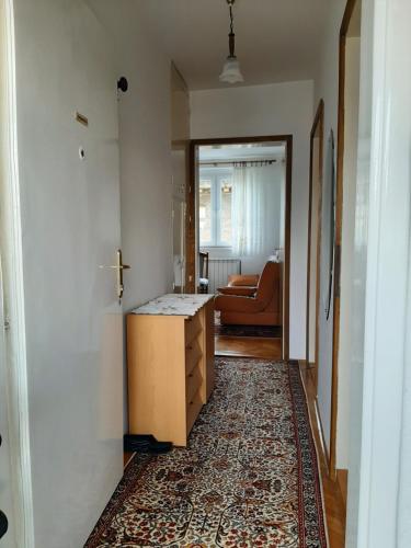 a living room with a table and a rug at Mimy Rooms in Sarajevo