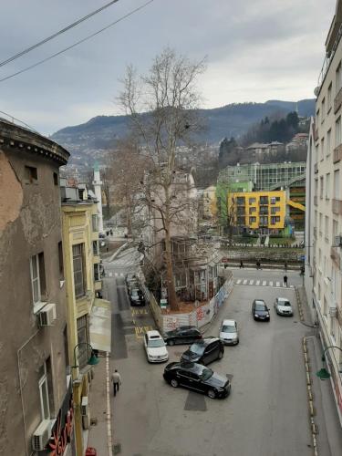 a view of a city street with cars parked at Mimy Rooms in Sarajevo