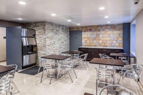 a restaurant with tables and chairs and a refrigerator at Umbrella Hotel Brooklyn in Brooklyn