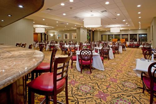 a banquet hall with tables and chairs in a restaurant at Wyndham Houston near NRG Park - Medical Center in Houston