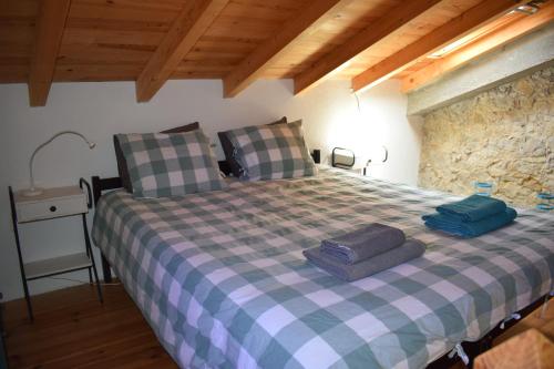 a bedroom with a bed with two pillows on it at Vale da Palha in Casal do Pardo