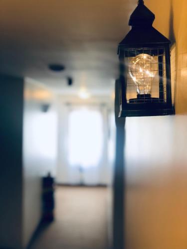 a lantern hanging on a wall in a room at Kalken Hotel by MH in El Calafate