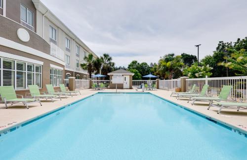 a swimming pool with lounge chairs and a building at Holiday Inn Express Hotel & Suites Dublin by IHG in Dublin