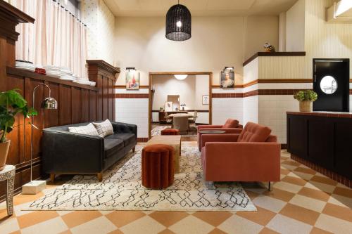 a living room with leather furniture and a mirror at Palihotel San Francisco in San Francisco
