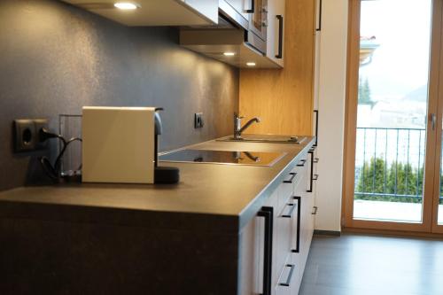 a kitchen with a sink and a counter top at Schlossbichl in Nauders