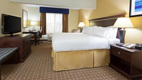 a hotel room with a large bed and a television at Holiday Inn Express and Suites Allentown West by IHG in Allentown