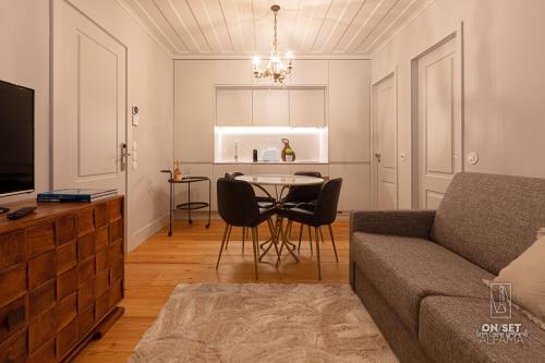 a living room with a couch and a table with chairs at ON/SET Alfama - Lisbon Cinema Apartments in Lisbon
