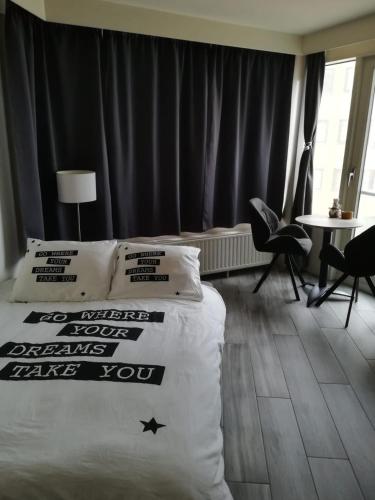a hotel room with a bed with pillows on it at WAW vakantie appartement in Middelkerke