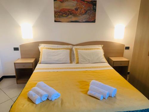 a bedroom with a large bed with two towels on it at B&B Ninni in Castelbuono