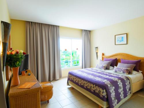 A bed or beds in a room at Djerba Resort- Families and Couples Only