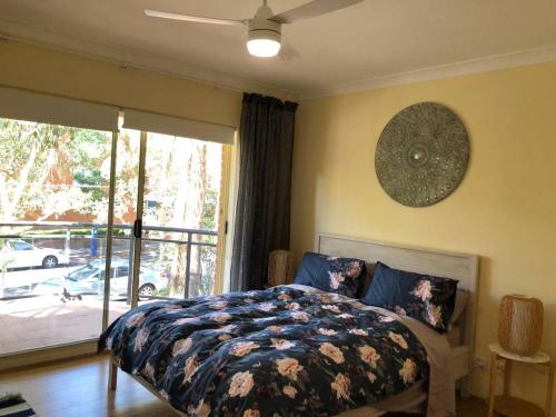 a bedroom with a bed and a large window at Escape to Strathfield for 8 guests in Sydney